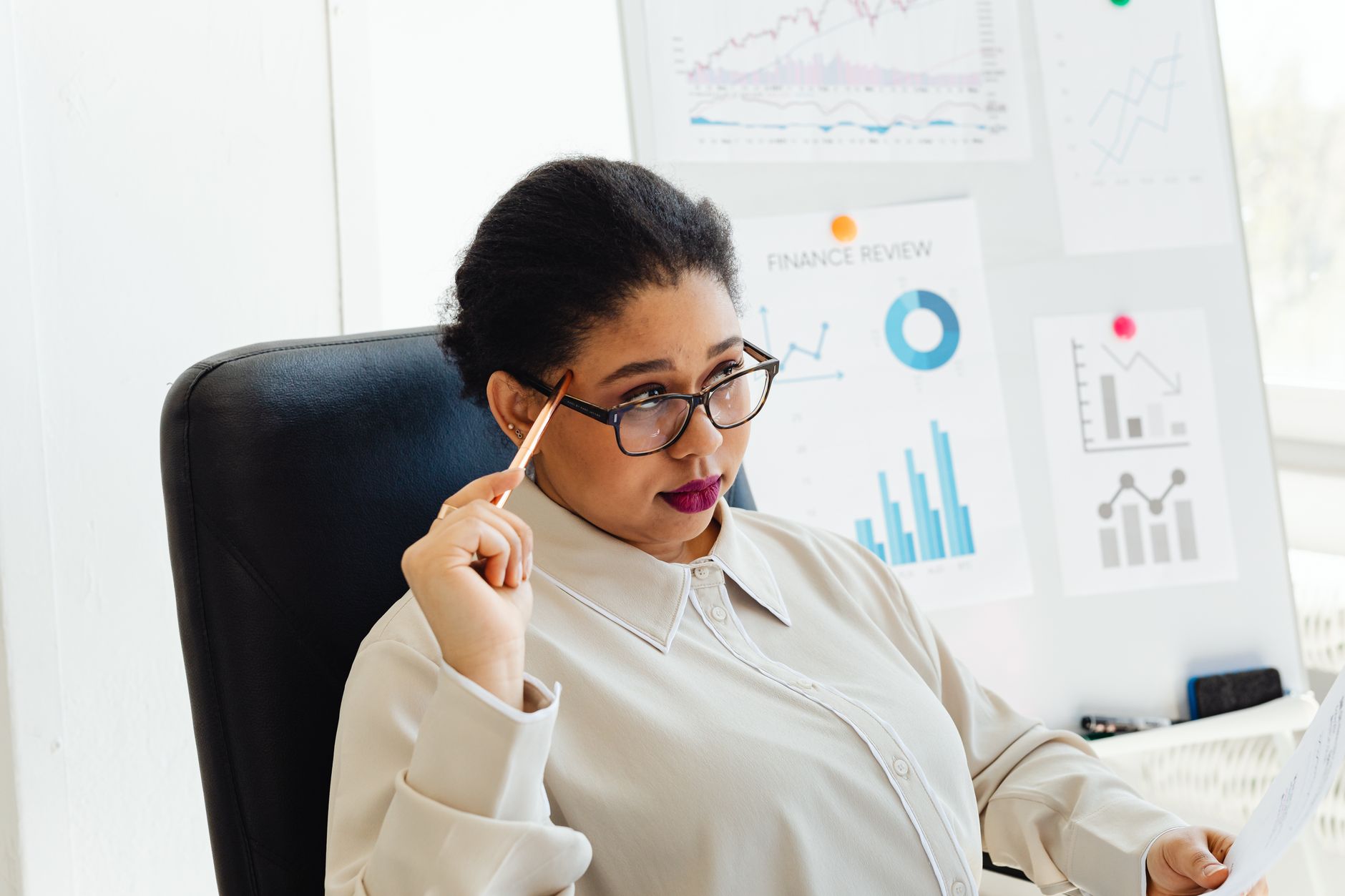 Executive in standard posture examining boardroom analytical metrics