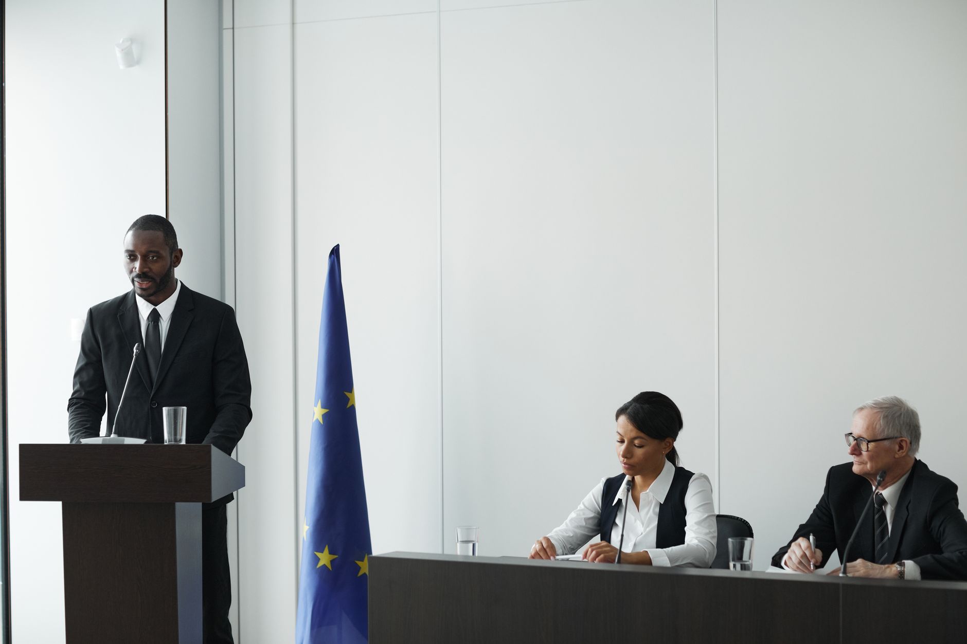 Global executive addressing international corporate panels with confidence